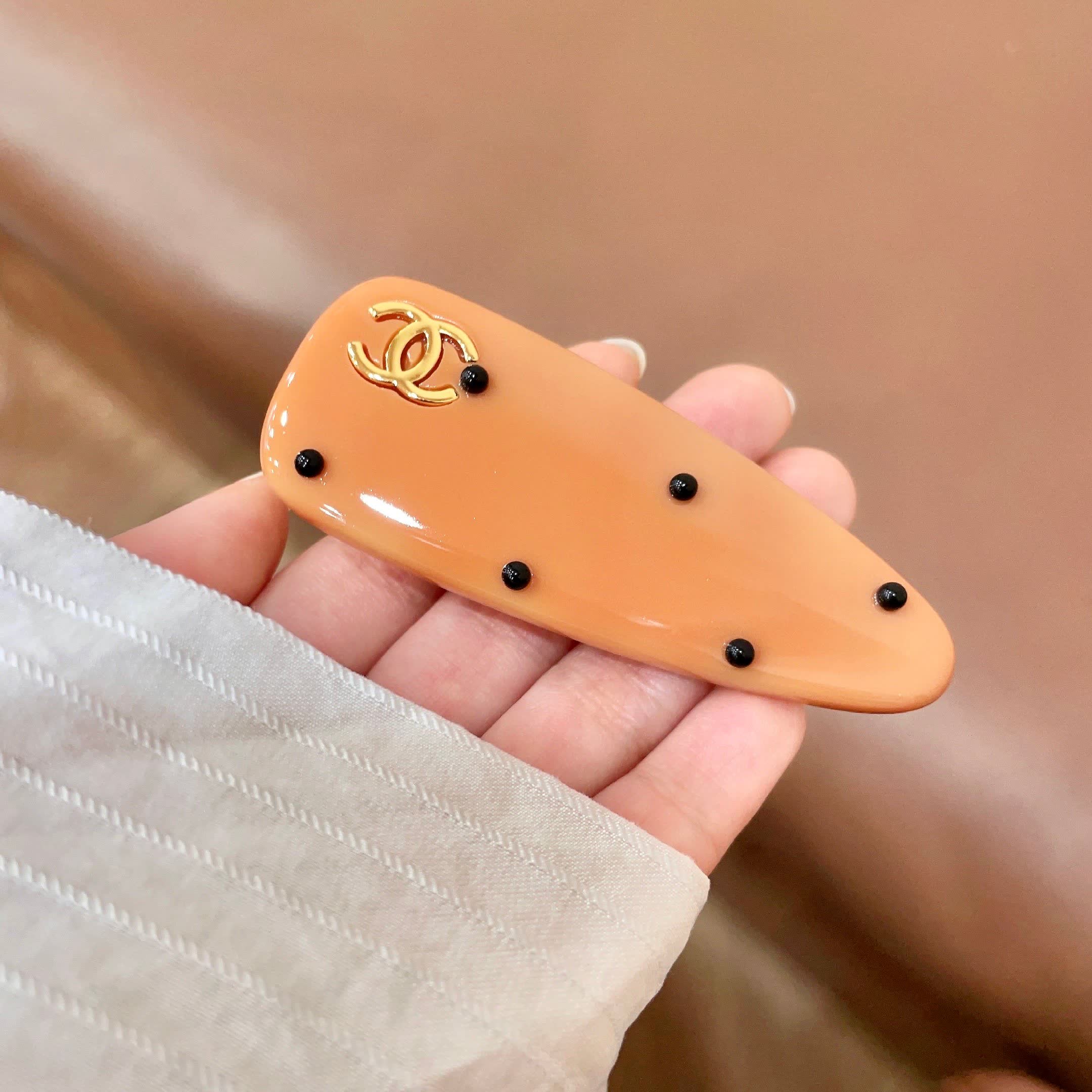Chanel Orange Hair Clip with Black Dots